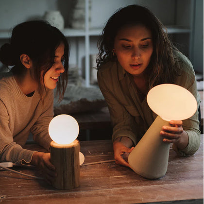 Two Creative Professionals Discussing Tala Lamp Designs. Collaborative Inspiration for Modern Lighting