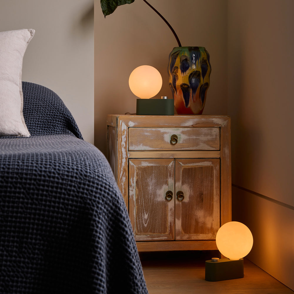 A set of two Alumina Multi-Use Lamps in Sage Green, perfect for any desk or bedside setting. Alumina has dim-to-warm technology to make it suit any space.