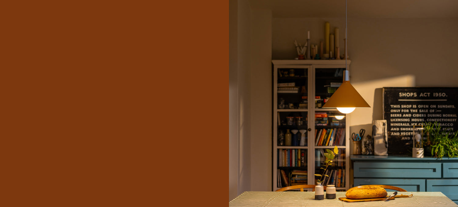 Bower Pendant Light Medium in Yellow in a dining room setting.