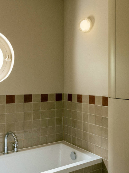 Firth Wall Light by Tala: an IP65-rated puck light mountable on a wall or mirror. Fit with Dim-to-Warm technology, Firth provides a perfect glow indoors or outdoors.