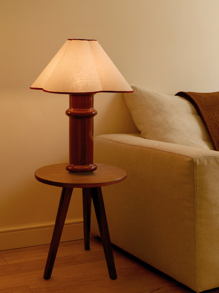 heath table lamp next to living room sofa on a side table