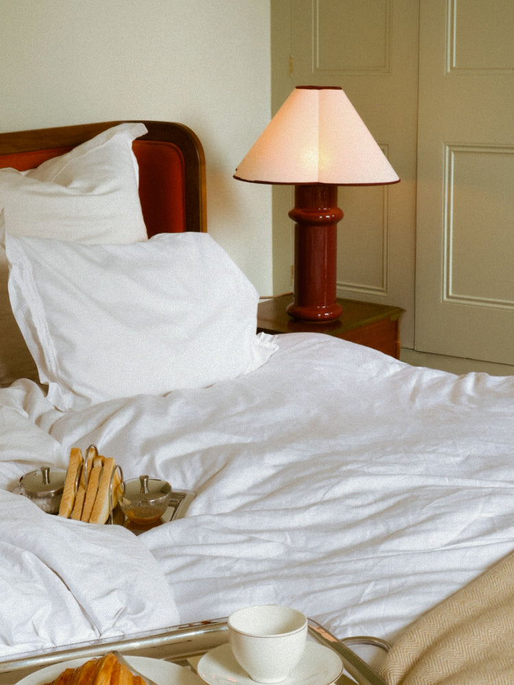 heath table lamp next to boutique bed on a side table