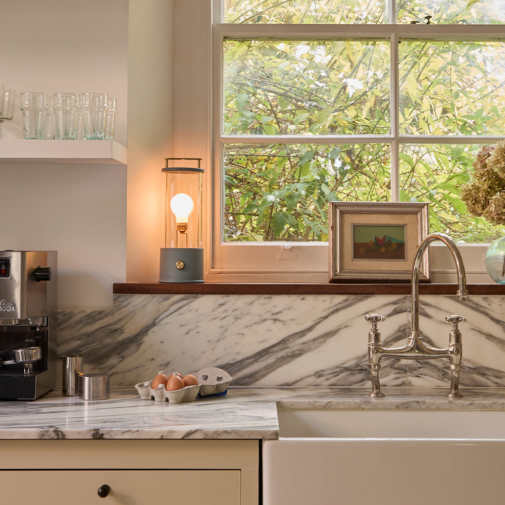 Lifestyle shot of Tala Muse Portable Lamp in Selvedge Blue, adding style and light to the kitchen.