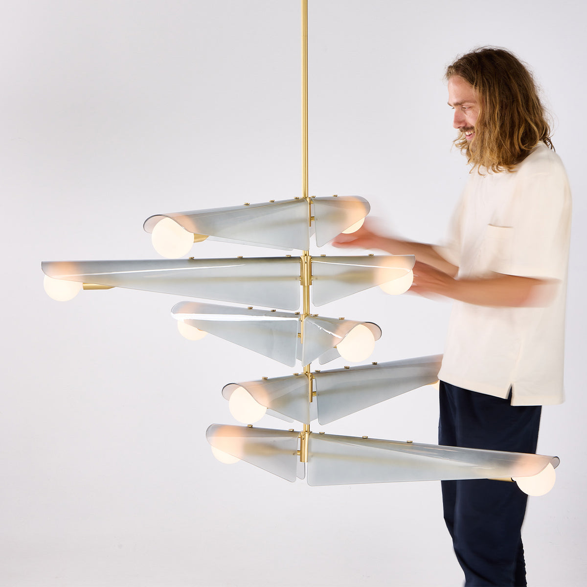 An image of Dan Carpenter the Head of Design at Tala with the Sycamore chandelier