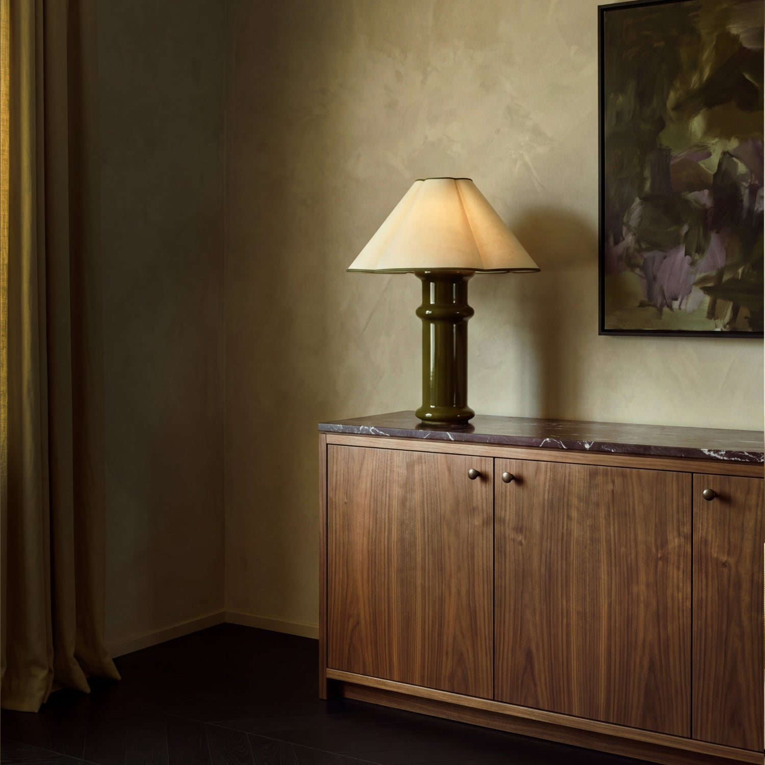 Lit Heath Table Lamp on a marble-topped walnut sideboard beneath an abstract painting