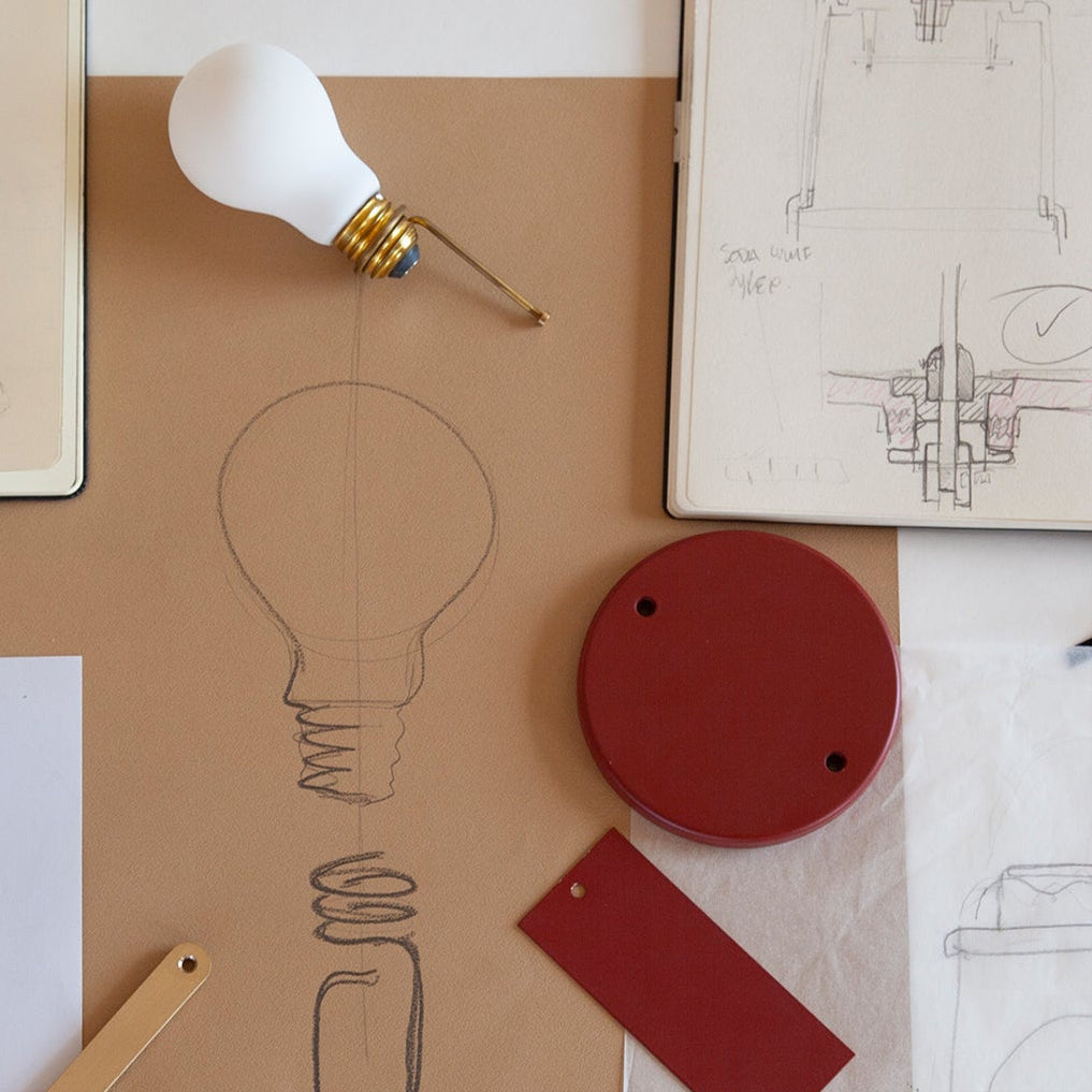 Lifestyle photo of Tala Muse Portable Lamp in Pomona Red, lifestyle shot highlighting its unique sketch design.